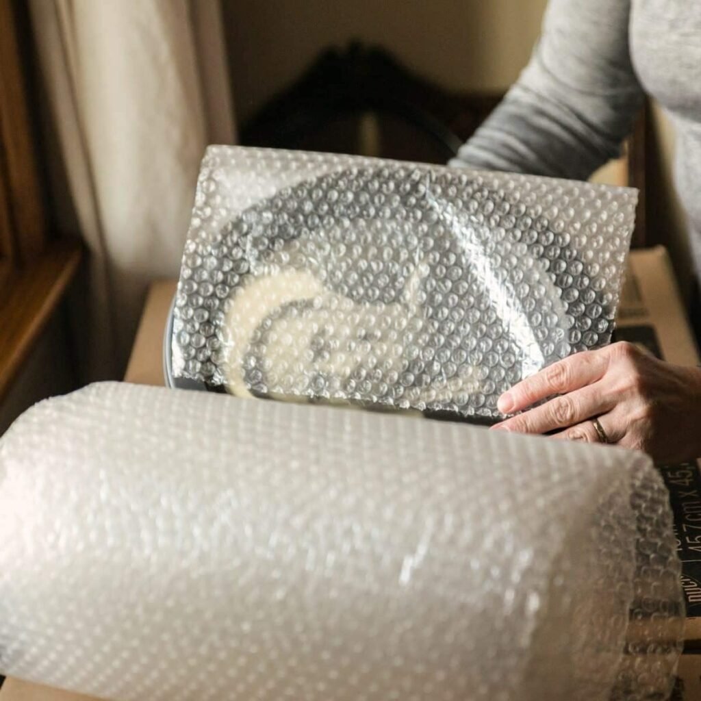 Packed shipping box with bubble wrap visible inside
