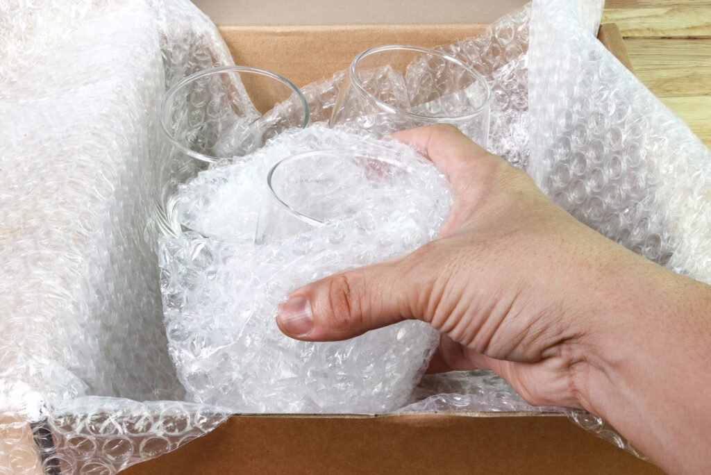 Item being wrapped in bubble wrap (electronics or glassware)